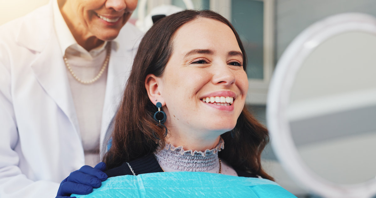 Teeth, smile and mirror with woman at dentist for dental care, treatment and fresh breath. Cleaning, tooth whitening and happy person for oral hygiene, orthodontics or wellness with veneer inspection.
