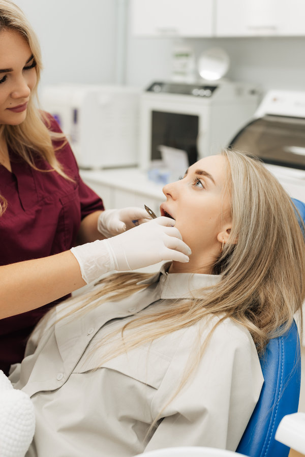 The dentist makes a dental impression to install braces for the patient. Close-up. Real people