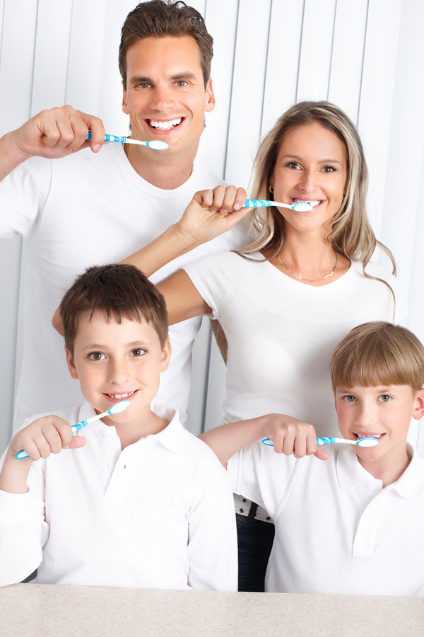 Happy family toothbrushing. Father, mother and children with toothbrushes.