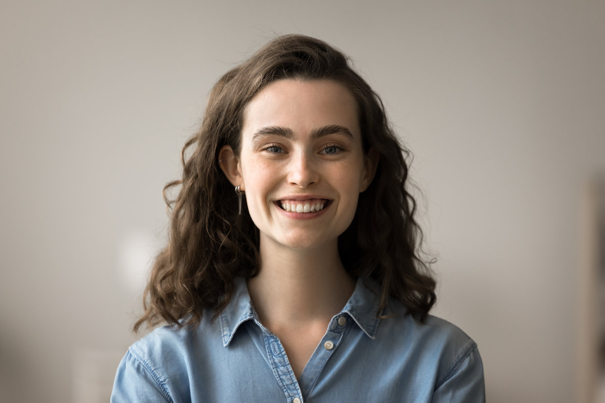 Head shot beautiful positive young woman having attractive appearance, optimistic mood and perfect white toothed smile posing for camera. Portrait of happy female, generation Z person profile picture