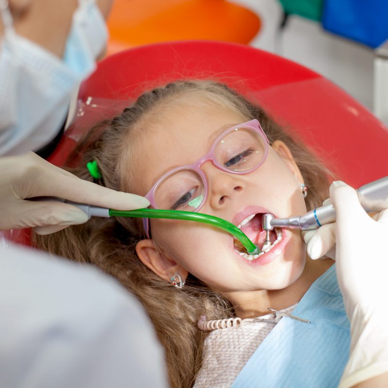 A child with a dentist in a dental office