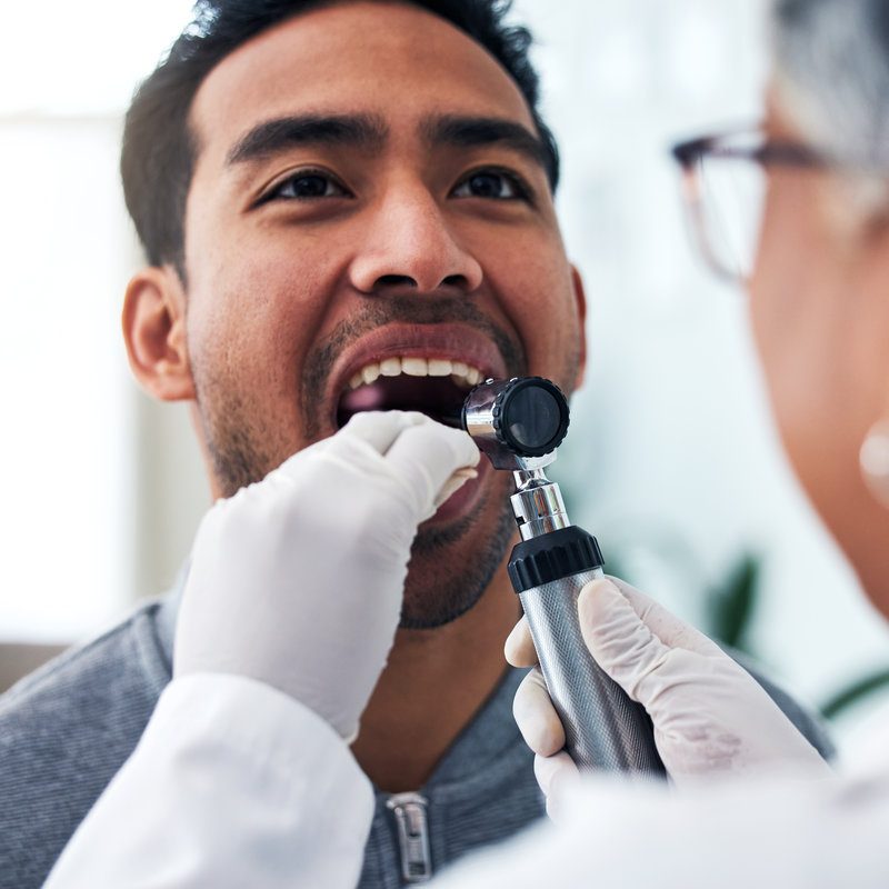 Medical, check and doctor with person and throat in hospital for cancer, sick and surgery. Medicine, healthcare and consulting with woman and patient in clinic for wellness, virus and oral exam.